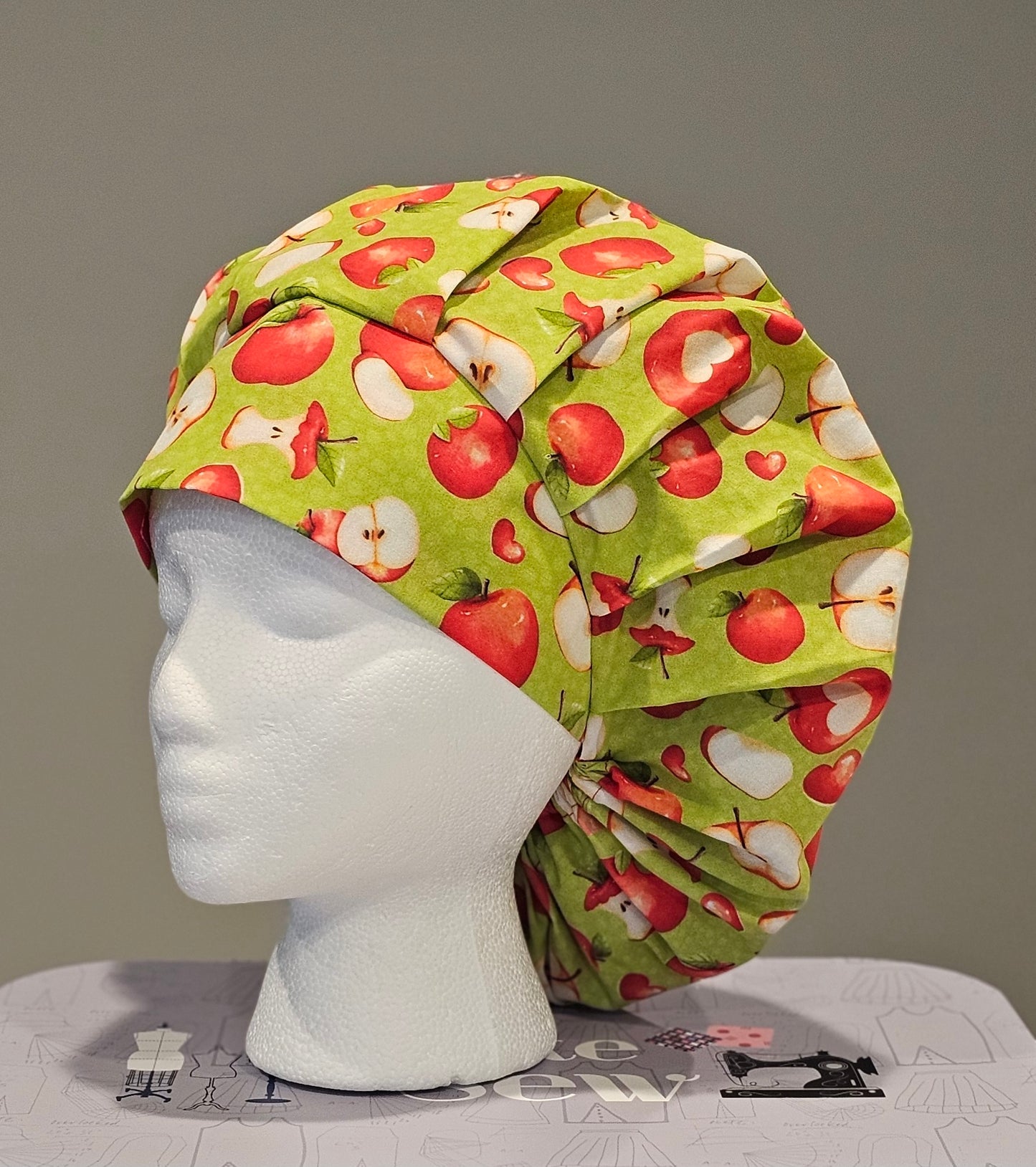 Red Apple Slices On Green Scrub Caps